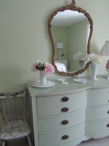 A mirror, chair, and a variety of lighting are good essentials for any guest room.
