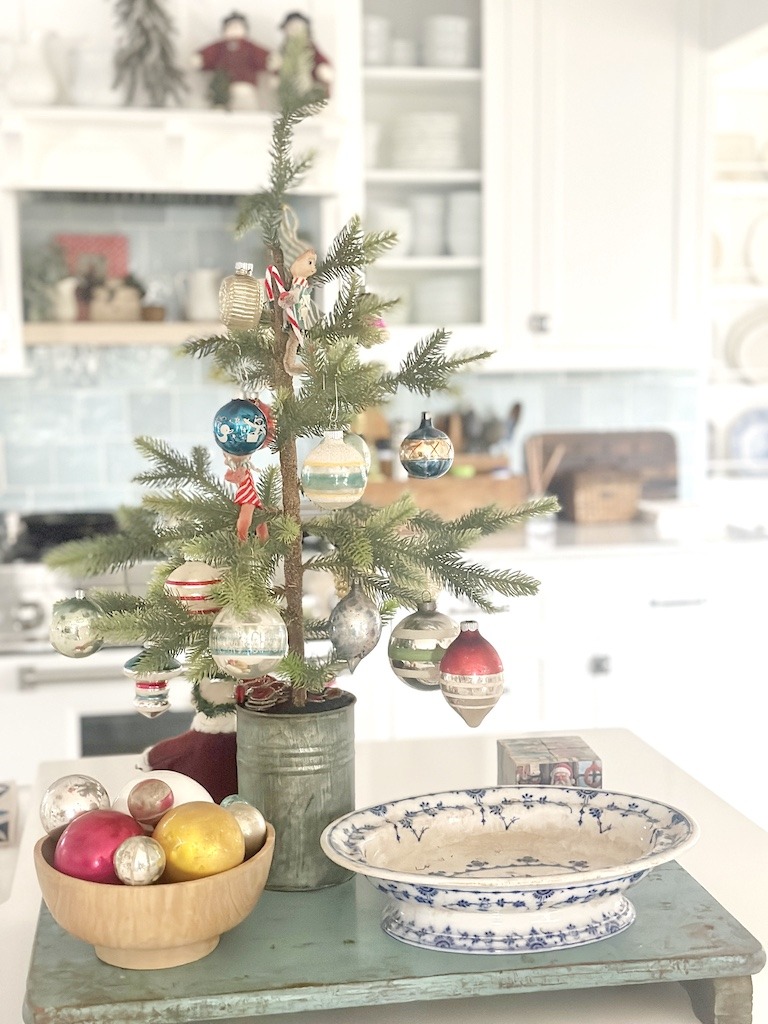 small artificial Christmas tree with vintage ornaments