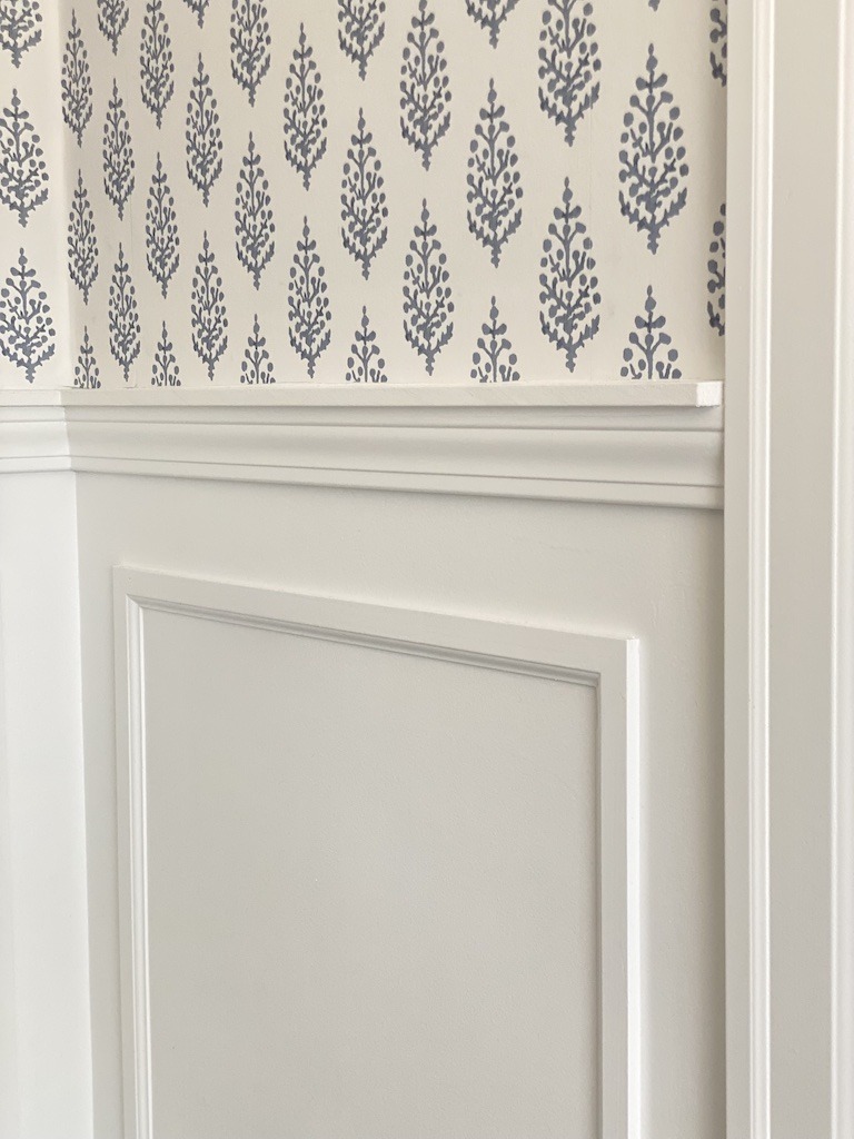 custom wall treatment with moulding and wallpaper