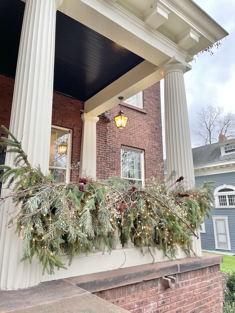front porch railing at Jean Stoffer Madison house with Christmas decorations