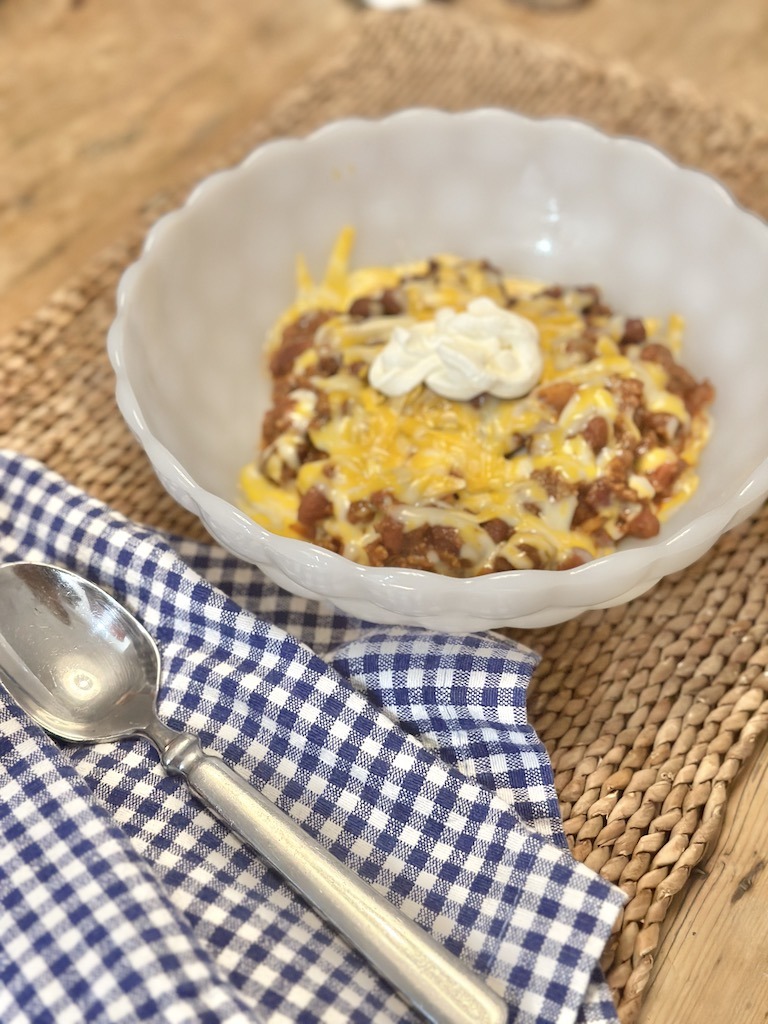 serving a quick and easy chili in a milk glass bowl