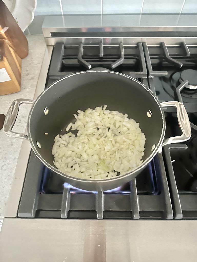 cooking chopped onion on stove top for quick and easy chili recipe
