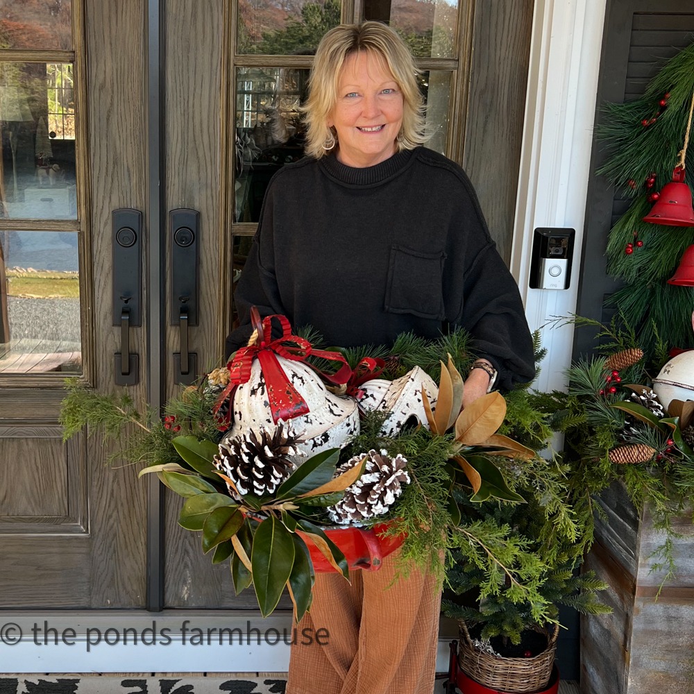 decorating the outdoor front porch with wreaths and fresh greenery