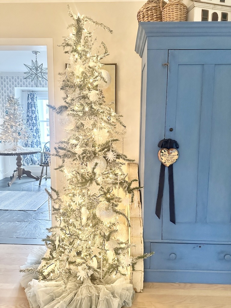 white flocked Christmas tree with blue and white room decor