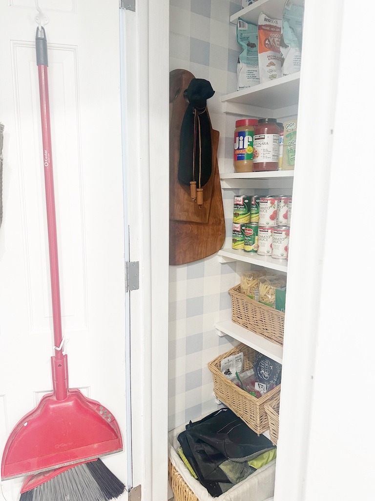 small broom closet turned pantry with shelves and pretty organization