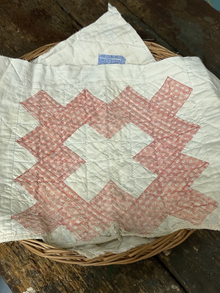 quilt squares at an estate sale shopping