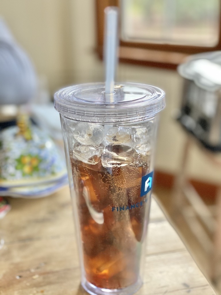 soda drink on ice in a cup on farmhouse table