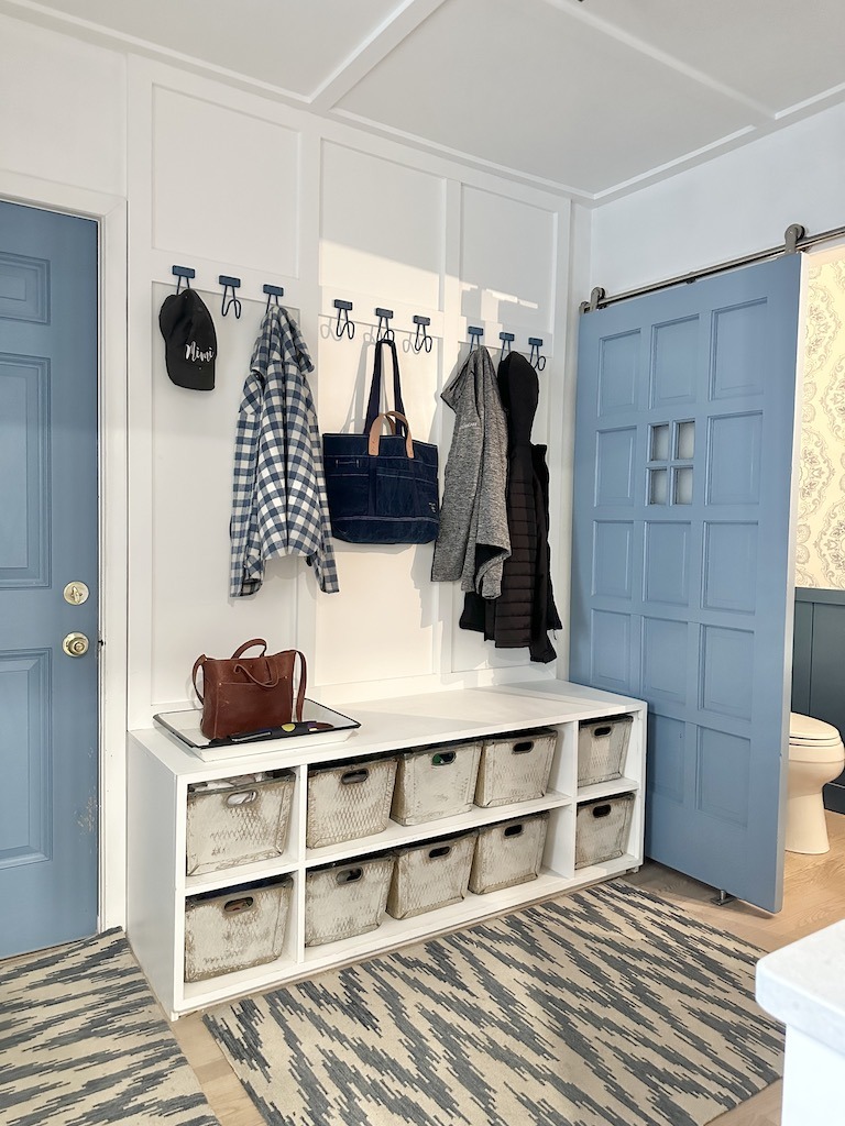 how to create a mudroom with the space that you have coat hooks and storage shoe cubbies