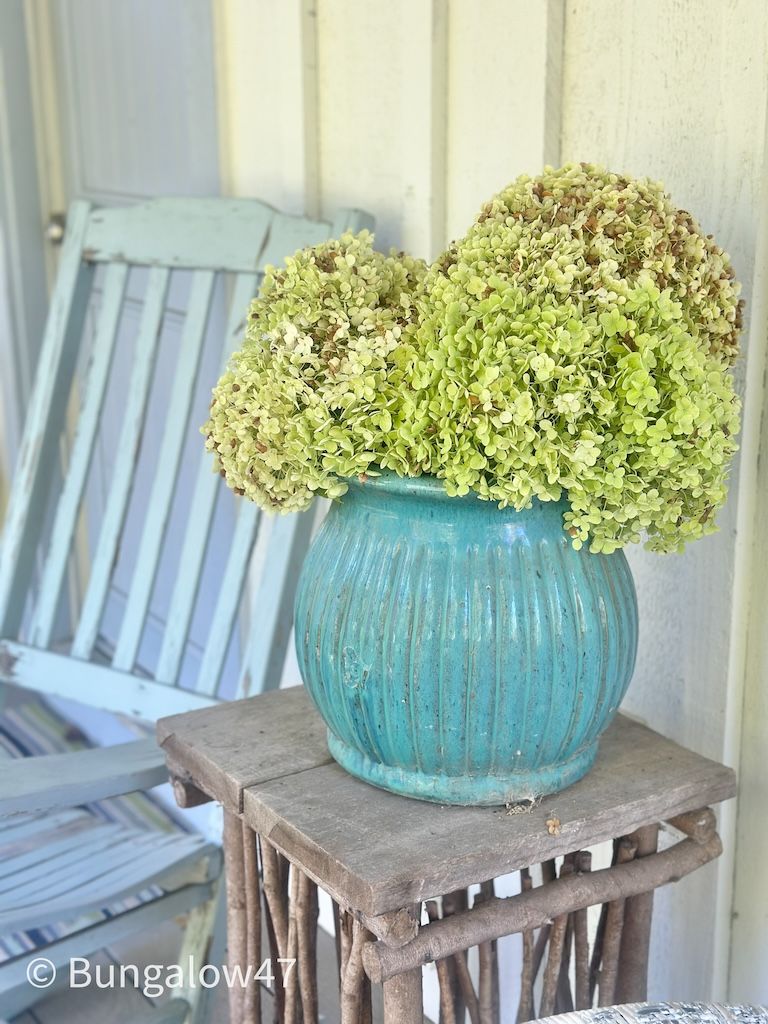 hydrangeas in a pot on a porch table