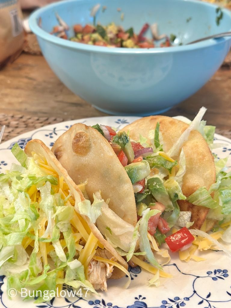 tacos on a plate with. a bowl of pico