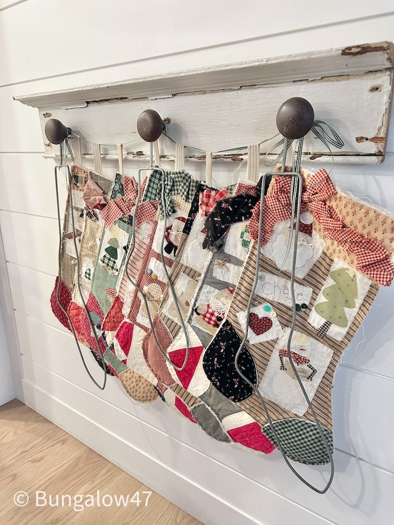 metal sock stretchers and christmas stockings hanging together