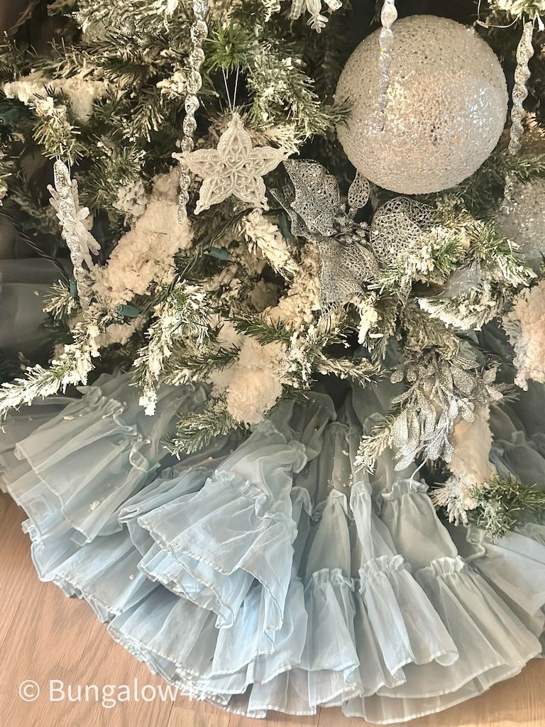 pale blue ruffled slip used as a Christmas tree skirt
