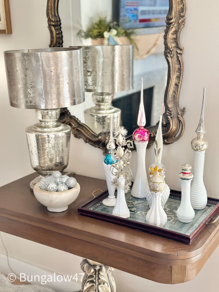 milk glass vases with Christmas tree toppers displayed